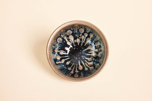 Top view of Tadpole Tenmoku tea bowl showing heavy iron speckled glaze