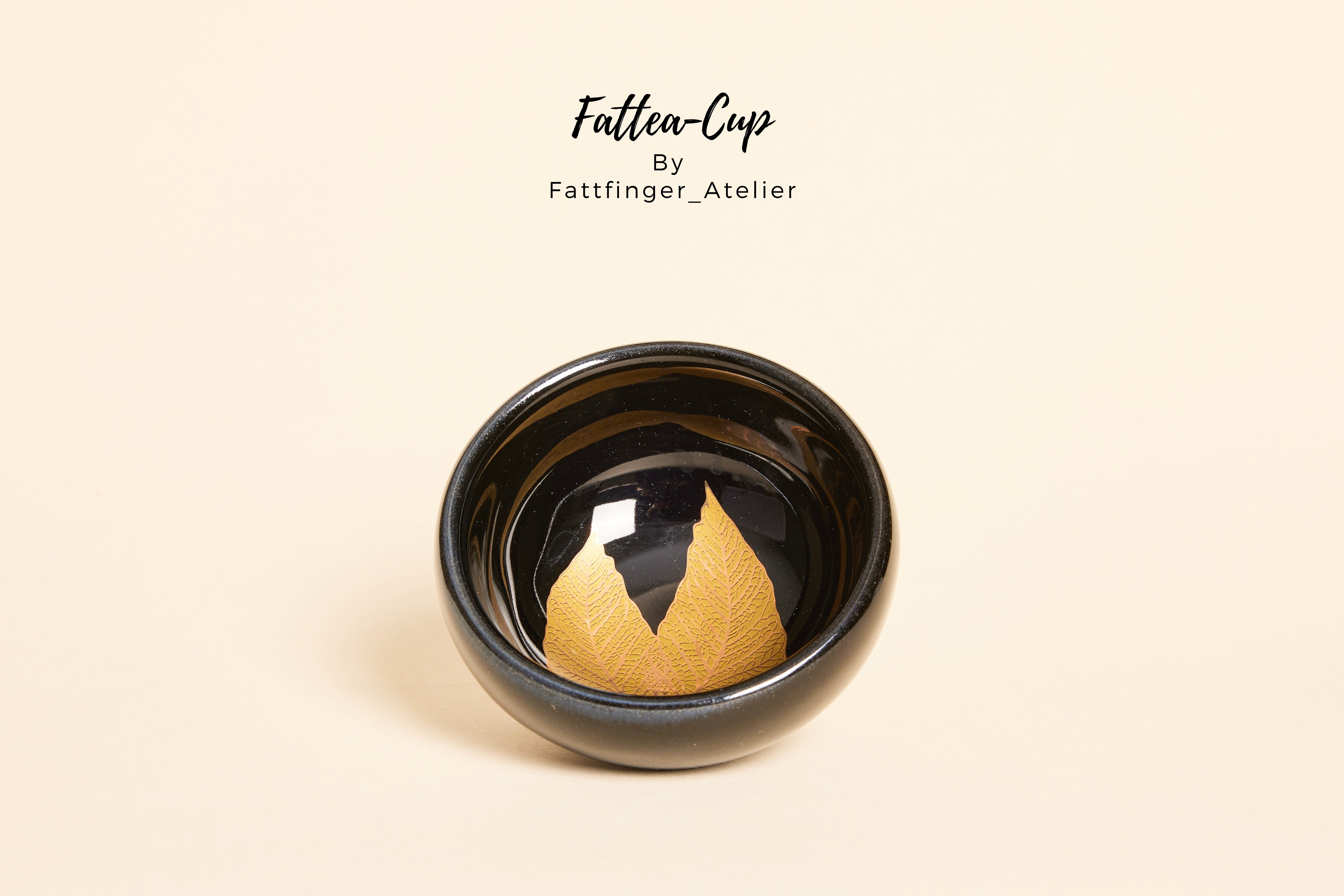 Leaves of Alchemy Tenmoku Jianzhan tea cup with black glaze and twin leaf patterns